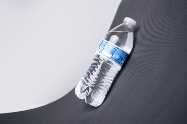 water bottle on smooth textured yoga mat